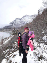 Brenda hiking with 2 kids in carriers