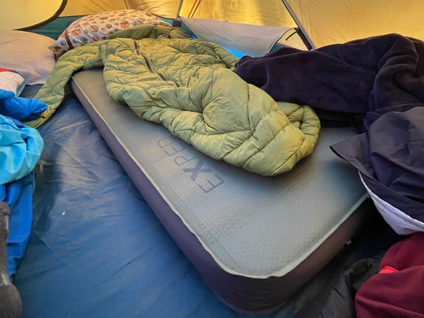 An Exped Megamat 10 inside a tent with an adult Morrison Outdoors Sleeping Bag on top