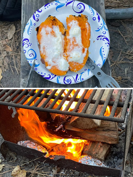 A sweet potato covered in marshmallow on a plate outdoors and wrapped sweet potatoes int he bottom of a campfire