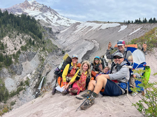 A family of seven hiking along a steep mountainous trail